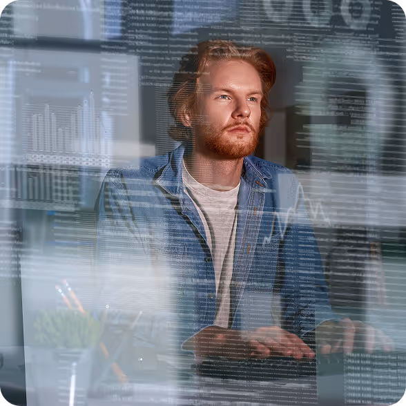 Jovem com cabelo e barba ruivos olhando pensativamente para gráficos e tabelas de dados digitais sobrepostos.